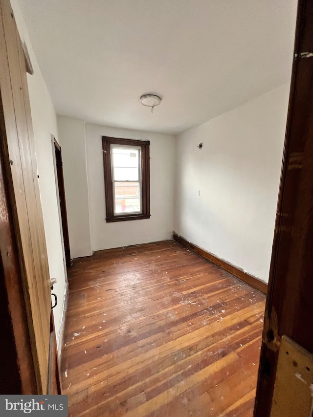 unfurnished bedroom with dark hardwood / wood-style floors