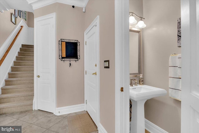 bathroom with tile patterned floors and crown molding