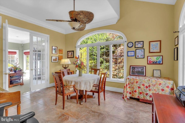 dining space with french doors, ceiling fan, and crown molding