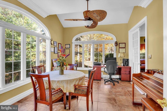 tiled dining space featuring lofted ceiling, ceiling fan, and plenty of natural light