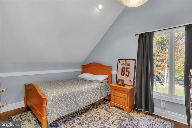 bedroom featuring vaulted ceiling and wood-type flooring