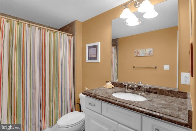 bathroom featuring toilet, a shower with curtain, and vanity