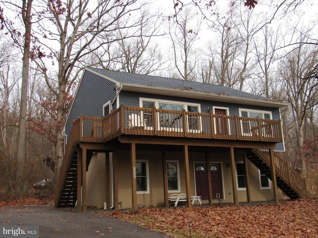 view of front of house featuring stairway and a wooden deck