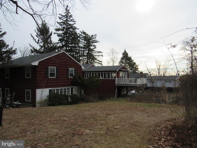 back of property featuring a wooden deck