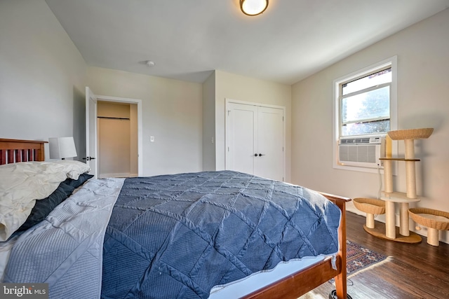 bedroom with hardwood / wood-style flooring, cooling unit, and a closet