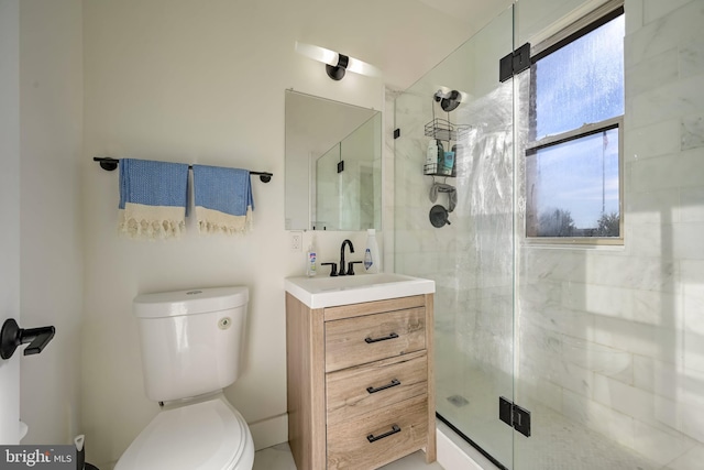 bathroom with vanity, toilet, and a shower with door