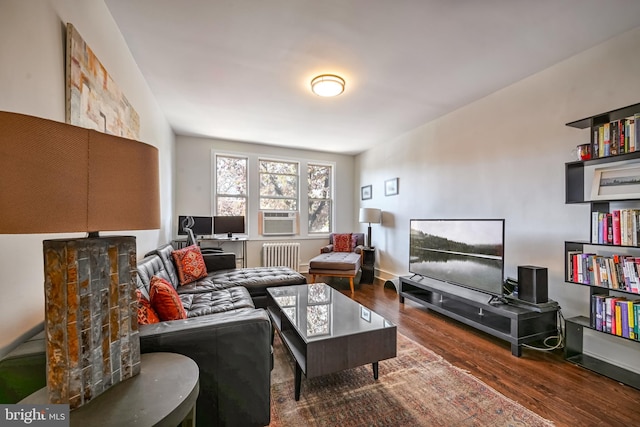 sitting room with radiator, dark hardwood / wood-style flooring, and cooling unit