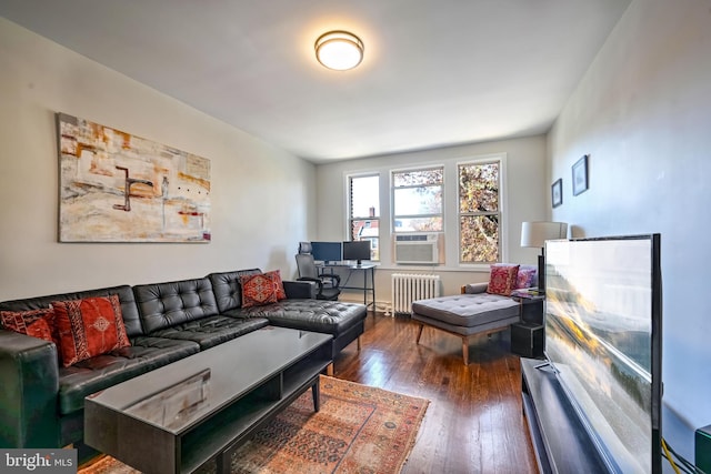 living room with dark hardwood / wood-style floors, cooling unit, and radiator