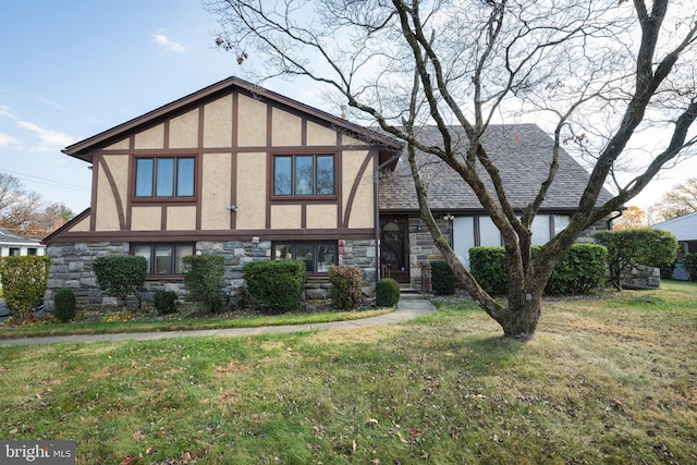 english style home featuring a front yard