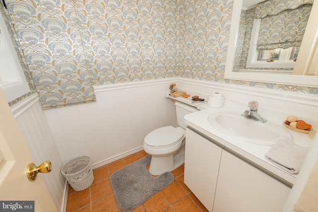 bathroom featuring toilet, vanity, and tile patterned flooring