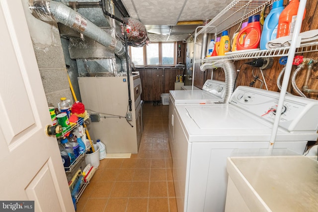 laundry area featuring heating unit, sink, and washer and clothes dryer