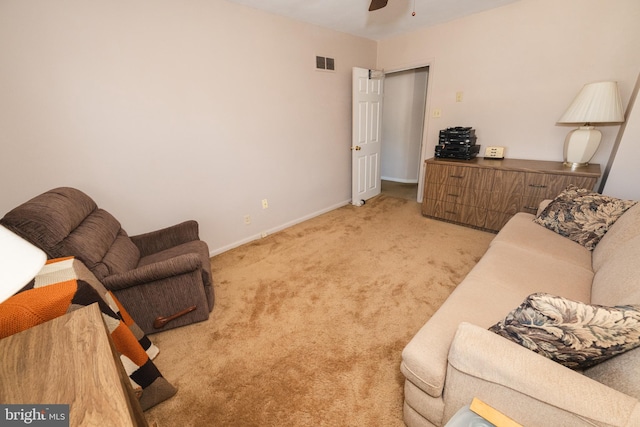 carpeted living room with ceiling fan