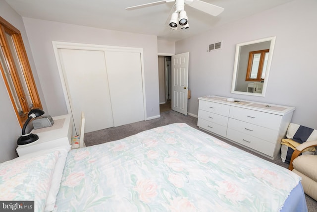 carpeted bedroom with ceiling fan and a closet