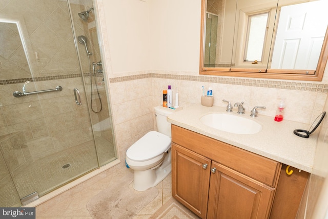 bathroom featuring tile walls, walk in shower, toilet, and vanity