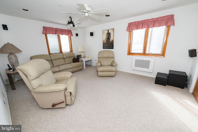 living room with a wall mounted AC, carpet, and ceiling fan