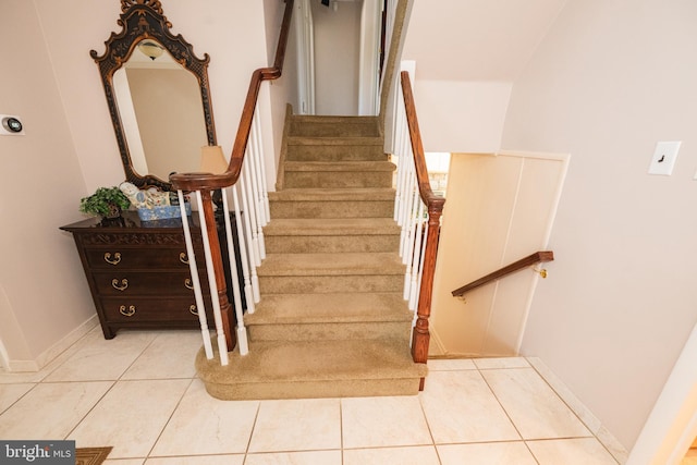 stairway with tile patterned floors