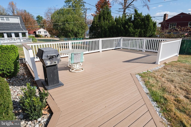 wooden terrace with a grill