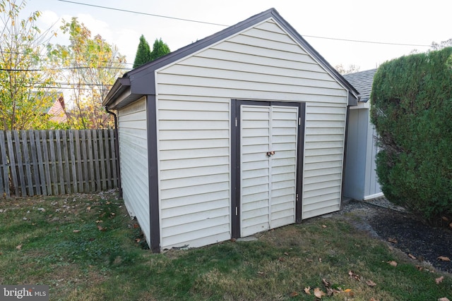 view of outbuilding featuring a lawn