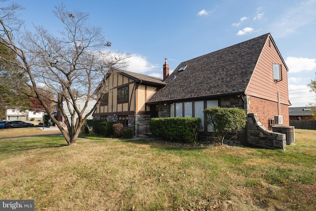 view of home's exterior featuring central AC unit and a yard