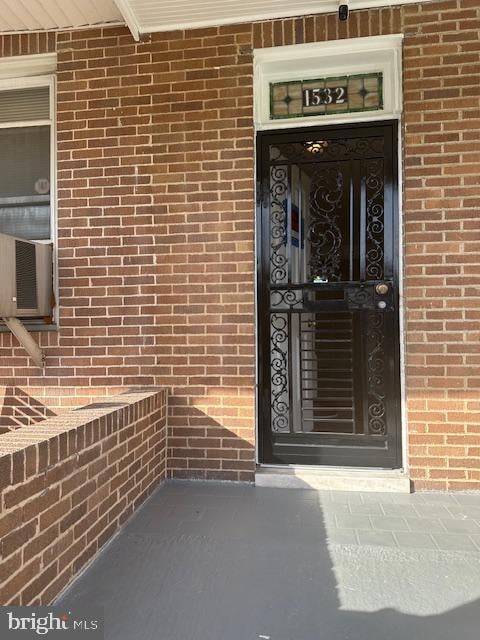 entrance to property featuring cooling unit