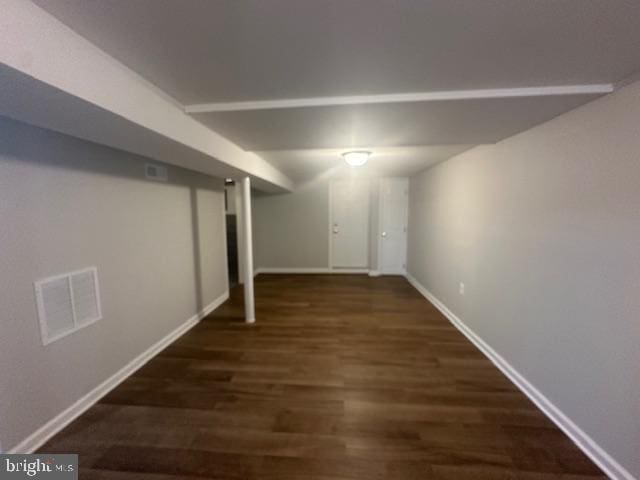 basement with dark hardwood / wood-style floors