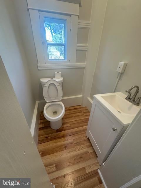 bathroom featuring hardwood / wood-style floors, vanity, and toilet