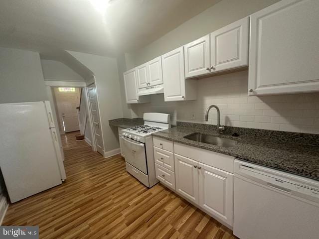 kitchen featuring white appliances, white cabinetry, sink, and light hardwood / wood-style flooring