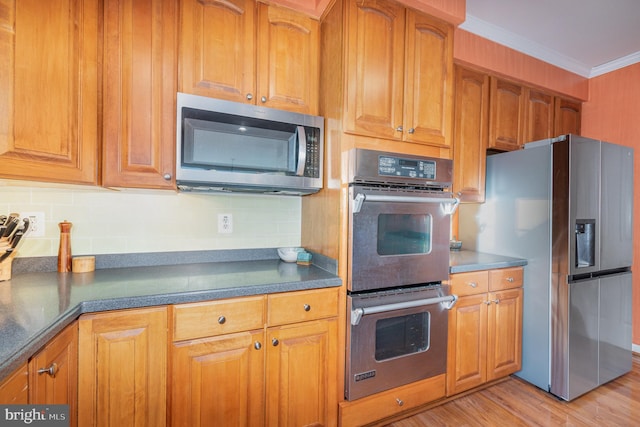 kitchen featuring decorative backsplash, crown molding, appliances with stainless steel finishes, and light hardwood / wood-style flooring