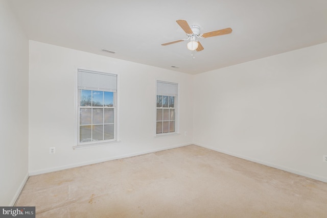 carpeted empty room featuring ceiling fan