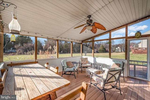 unfurnished sunroom with vaulted ceiling and ceiling fan