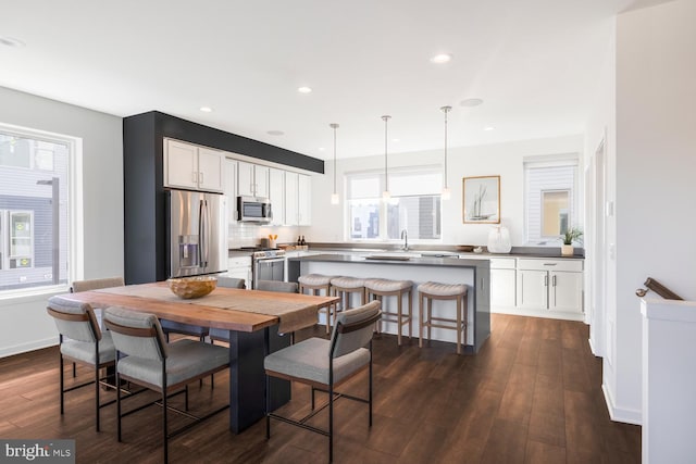 dining area with dark hardwood / wood-style flooring and sink