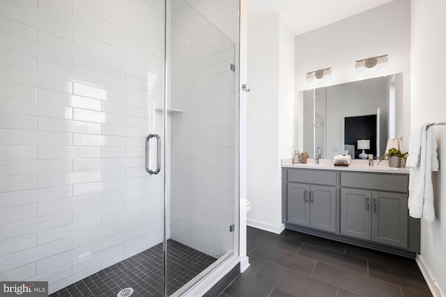 bathroom featuring walk in shower, vanity, tile patterned floors, and toilet