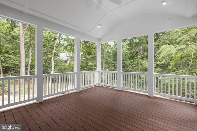 unfurnished sunroom featuring ceiling fan, a healthy amount of sunlight, and lofted ceiling