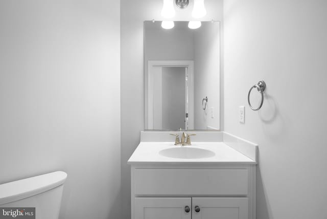 bathroom featuring toilet and vanity