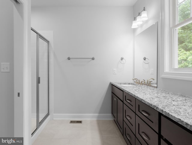 bathroom with vanity, tile patterned floors, and an enclosed shower