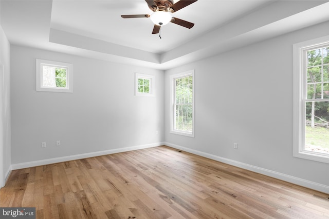 unfurnished room featuring light hardwood / wood-style flooring, a healthy amount of sunlight, and ceiling fan