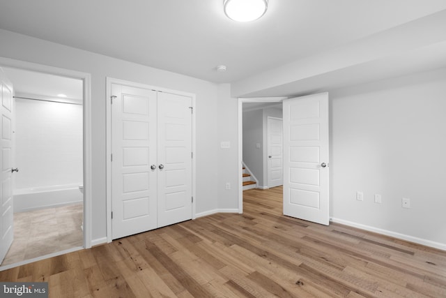 unfurnished bedroom featuring light hardwood / wood-style floors and a closet