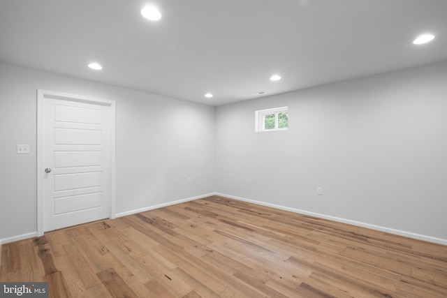 basement with light hardwood / wood-style floors