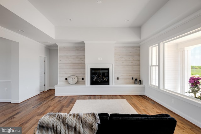 living room with wood-type flooring and crown molding