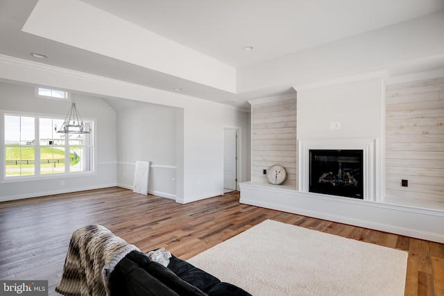 living room with hardwood / wood-style flooring and a notable chandelier