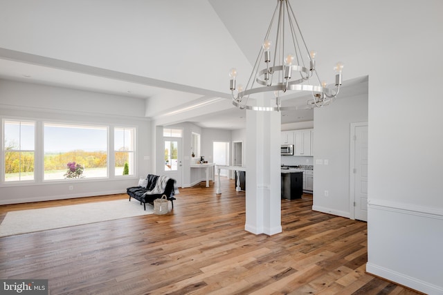 interior space featuring high vaulted ceiling and hardwood / wood-style flooring