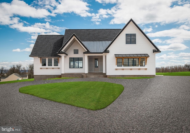 modern farmhouse style home with a front lawn