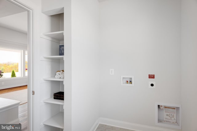 clothes washing area featuring washer hookup, electric dryer hookup, and light hardwood / wood-style flooring