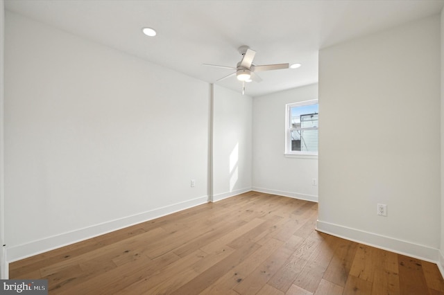 spare room with light hardwood / wood-style floors and ceiling fan