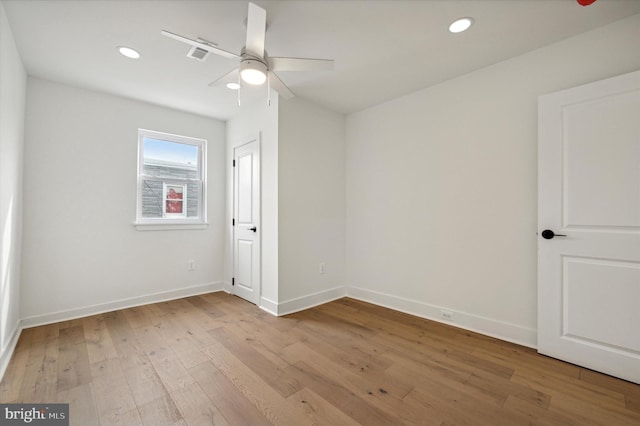 spare room featuring ceiling fan and light wood-type flooring