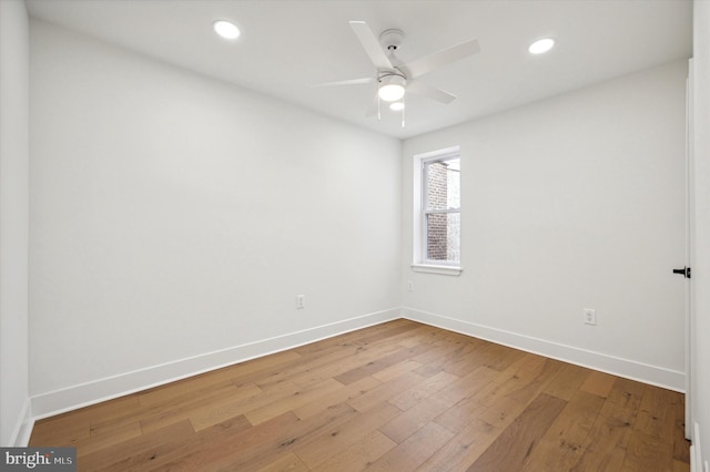 spare room featuring wood-type flooring and ceiling fan