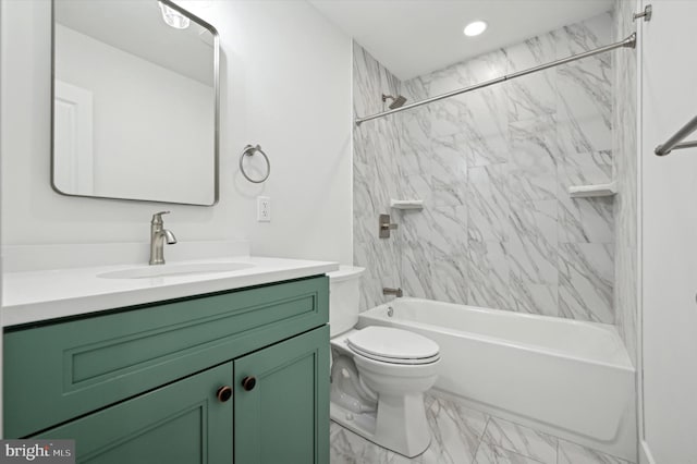 full bathroom featuring vanity, toilet, and tiled shower / bath