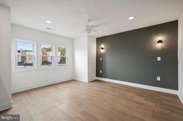 empty room with ceiling fan and light wood-type flooring