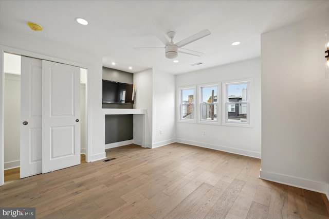 unfurnished living room with ceiling fan and light hardwood / wood-style floors