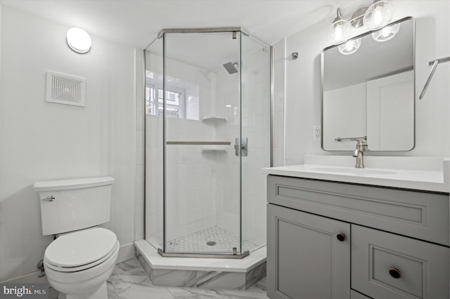 bathroom featuring vanity, toilet, and walk in shower